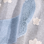 Soft kids woven rug with crescent moon and star designs in soothing blue and gray.
