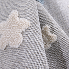 Kids rug featuring soft star patterns in soothing gray and cream colors.