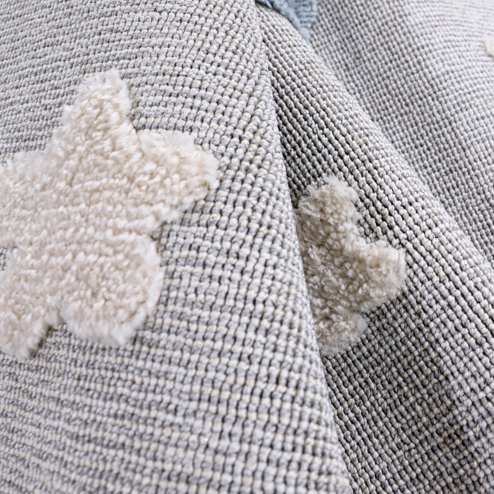 Kids rug featuring soft star patterns in soothing gray and cream colors.