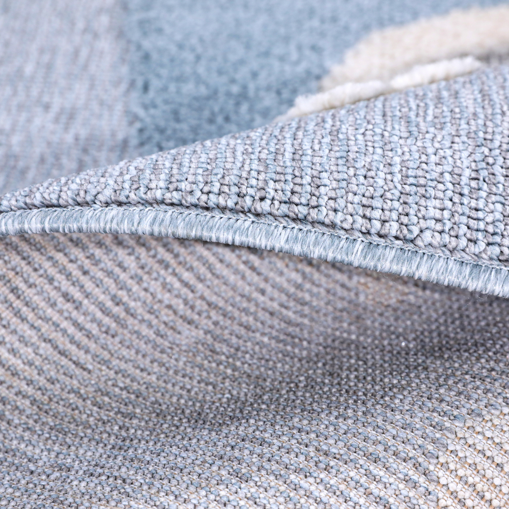 Textured close-up of blue and cream kids rug, ideal for playful bedroom decor.
