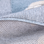 Textured close-up of blue and cream kids rug, ideal for playful bedroom decor.