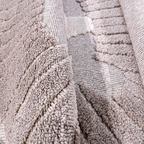 Soft textured detail of Distant Whispers Lion Woven Rug in neutral tones.