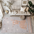 Quiet Lullaby Deer Woven Rug with a fawn and heart motifs in a stylish room setting.