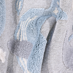 Gentle Tides Whale Woven Rug showcasing soft textures and pastel colors.