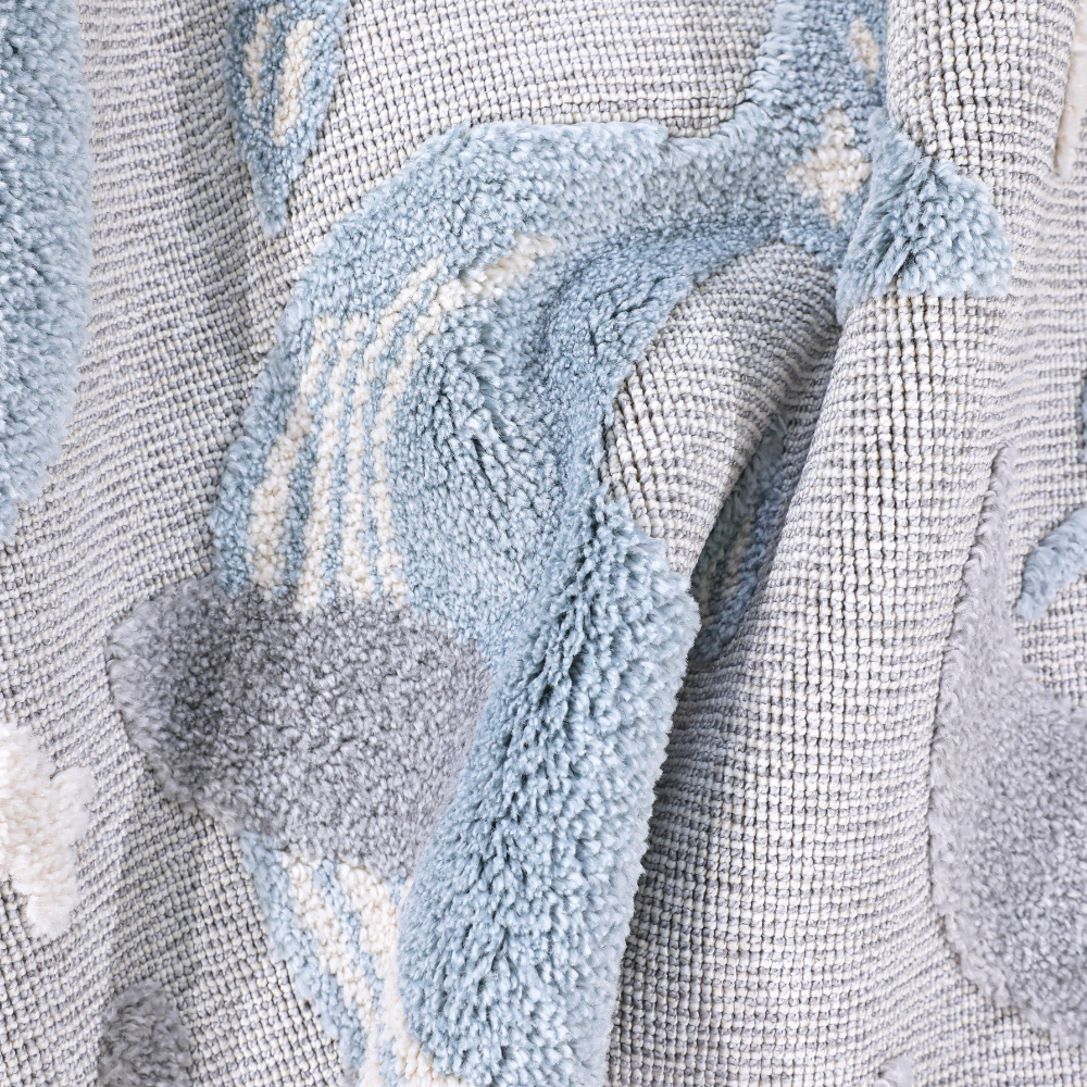 Gentle Tides Whale Woven Rug showcasing soft textures and pastel colors.