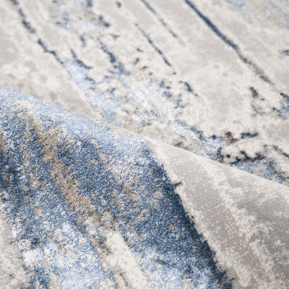 Juno Abstract Textured Rug in soft blue and gray, ideal for modern home decor.