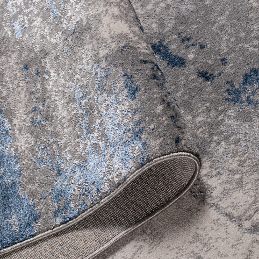 Reed Abstract Textured Rug in gray and blue, ideal for stylish home interiors.