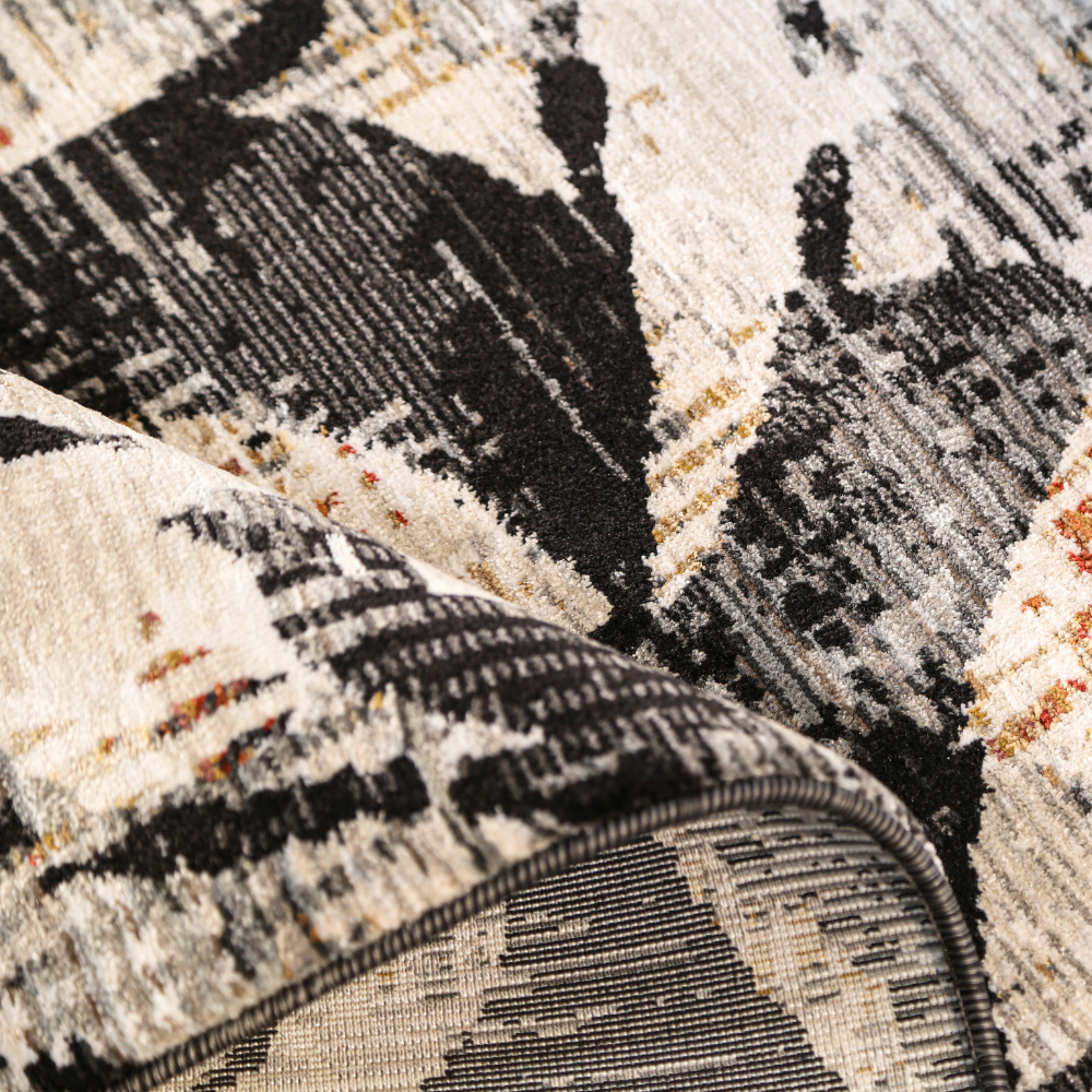 Textured lily flower rug in black, white, and orange featuring intricate design.