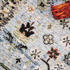 Symmetrical textured rug featuring floral and geometric designs in blue tones.