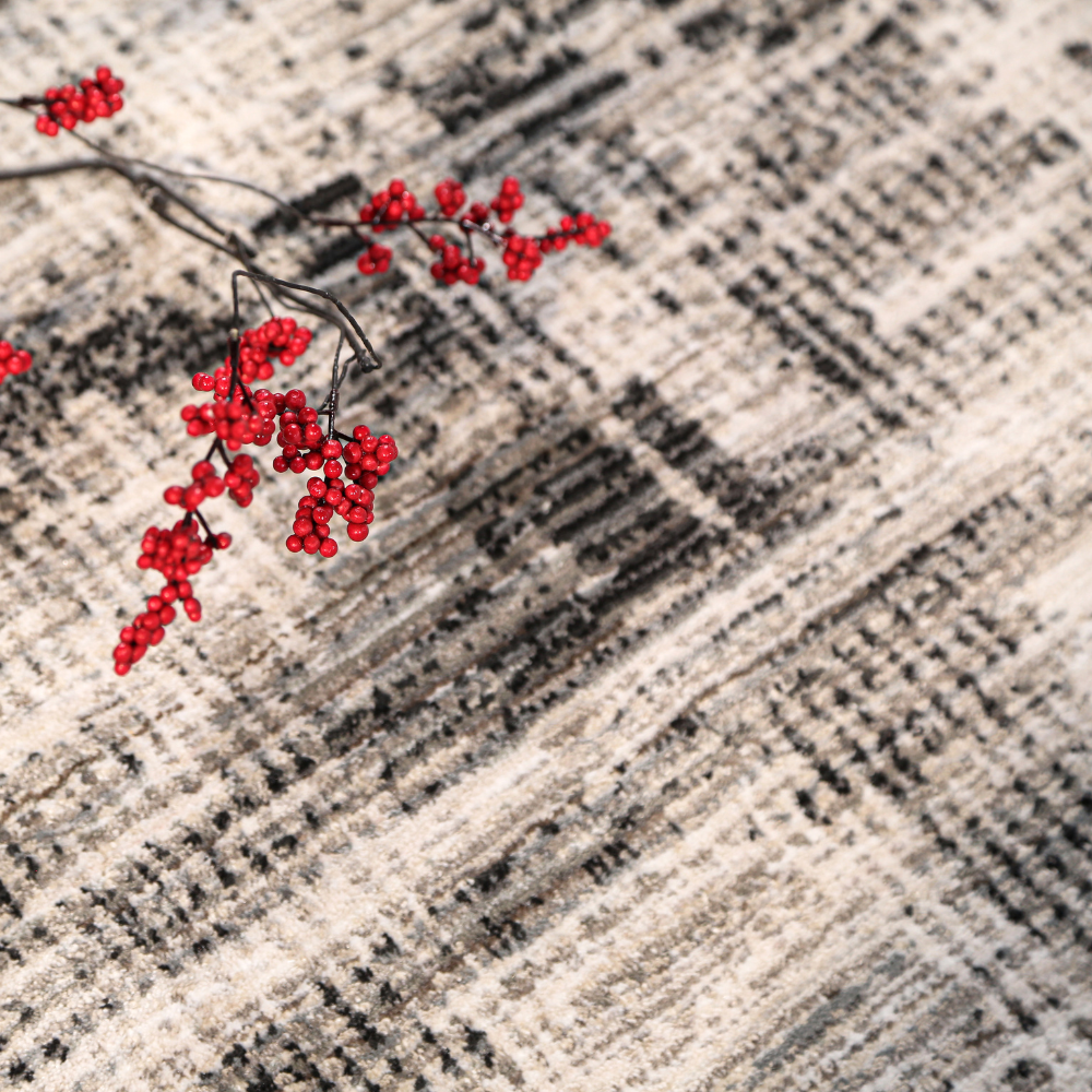 Luna Abstract Textured Rug in gray and cream, accented by red berries for modern decor.