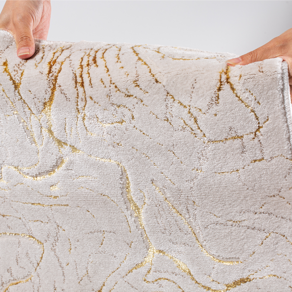 Pax Solid Textured Rug featuring gold accents and soft texture.