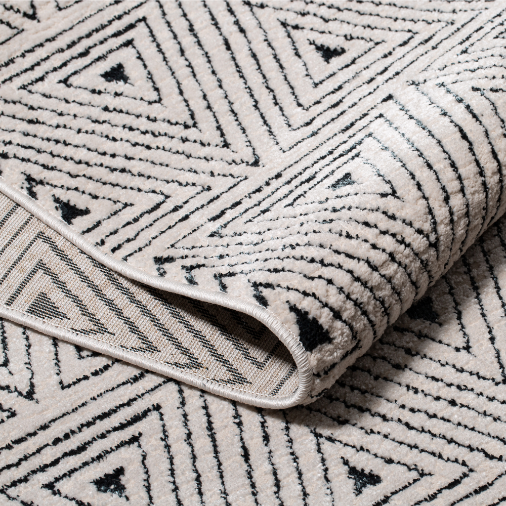 Zephyr Triangle Textured Rug with black and white geometric pattern.