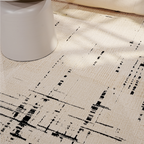 Thane Modern Textured Rug in cream with black abstract design and gray stool