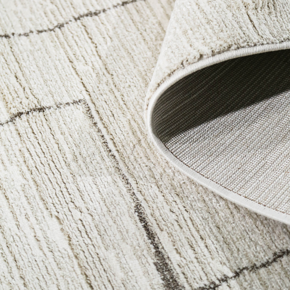 Aeron Abstract Textured Rug with subtle beige and cream tones, ideal for chic interiors.