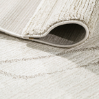 Thalion abstract textured rug in neutral tones with rolled edge, perfect for modern decor.
