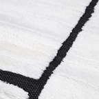 Eldrin geometric textured rug close-up in cream and black colors