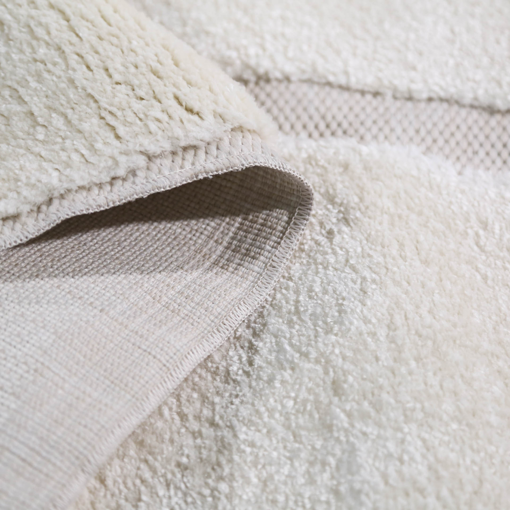 Lorien Stripe Textured Rug showcasing soft cream texture and layered construction.