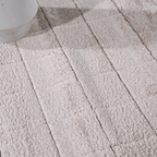 Close-up of beige checkered textured rug for modern home interiors