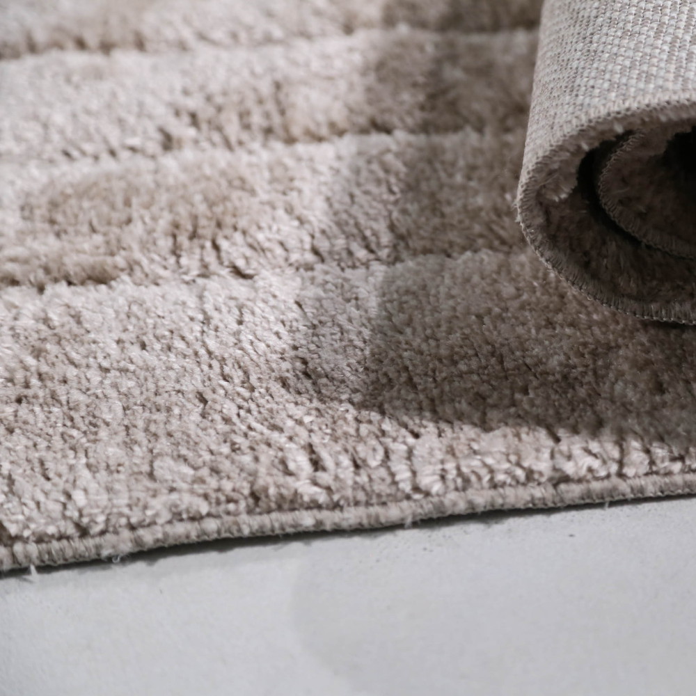 Close-up of Callidora geometric textured rug showcasing soft fabric and design