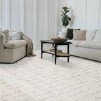 Iskander Stripe Textured Rug in cream, enhancing a stylish living room setting.